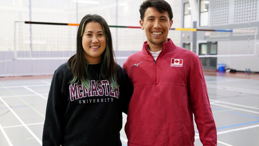 Kayla and Justin Lui on a volleyball court.