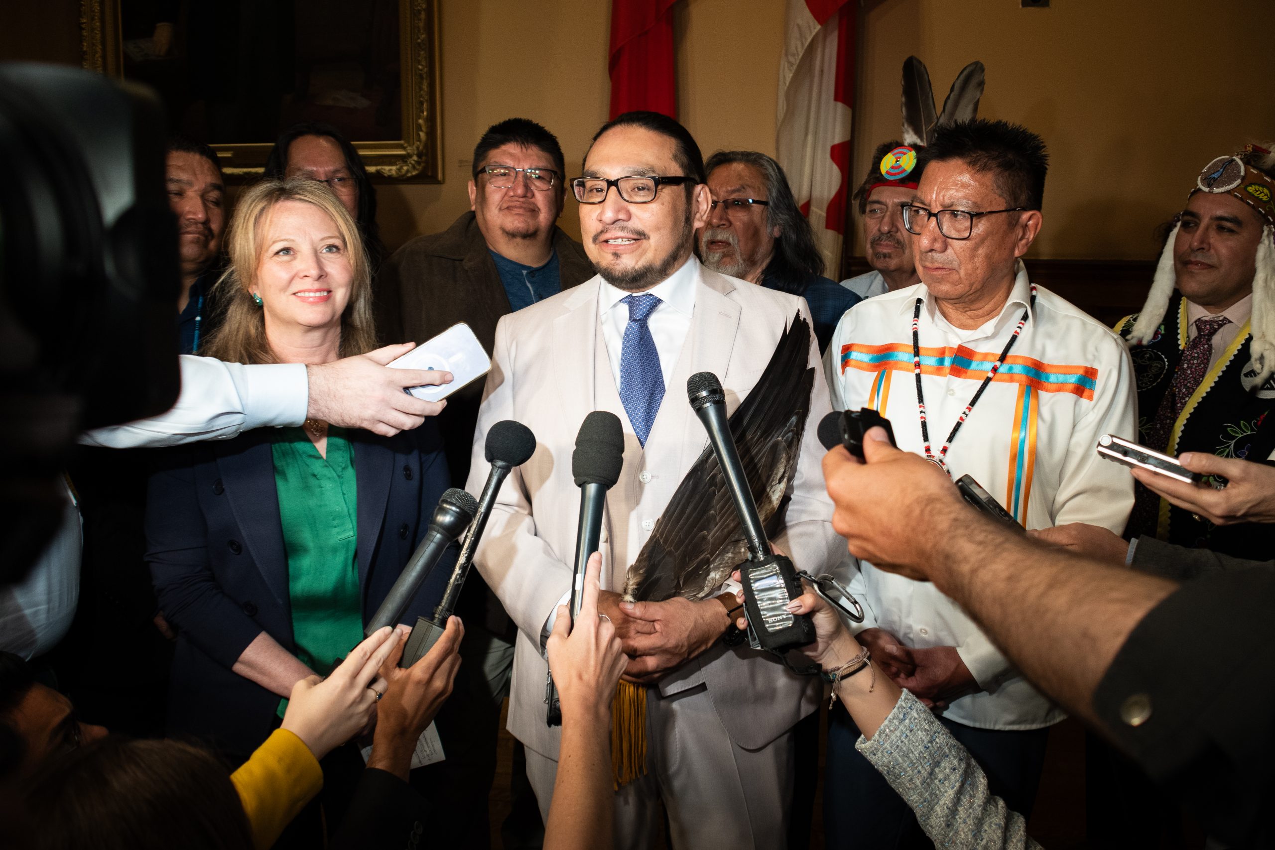 MPP Sol Mamakwa flanked by reporters