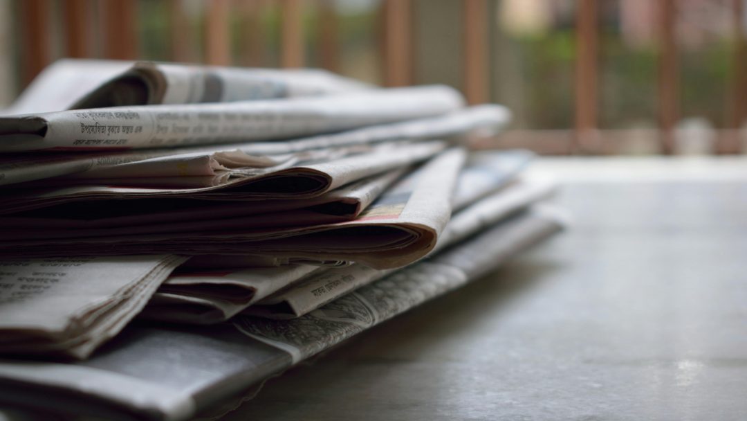 Stack of newspapers on a desk